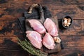 Chicken thigh fillet, Raw Boneless and skinless meat on a cutting board. Wooden background. Top view