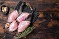 Chicken thigh fillet, Raw Boneless and skinless meat on a cutting board. Wooden background. Top view. Copy space