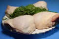 Chicken thighs on a blue background. Royalty Free Stock Photo