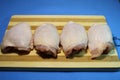 Chicken thighs on a blue background. Royalty Free Stock Photo