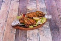 Chicken thighs cooked in tandoori style on top of boiling plate with aluminum foil on the edges of the bone