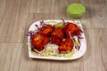 chicken tikka or chicken kebab in plate on wooden background