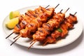 Chicken tikka kebab on white plate, closeup. Chicken satay skewers isolate on white background Royalty Free Stock Photo