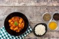 Chicken tikka masala with basmati rice in black bowl on wood Royalty Free Stock Photo