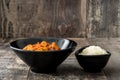 Chicken tikka masala with basmati rice in black bowl on wood Royalty Free Stock Photo