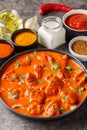 Chicken tikka masala is a dish consisting of roasted marinated chicken chunks in a spiced creamy sauce closeup on the plate. Royalty Free Stock Photo