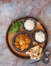 Chicken tikka masala, spicy curry meat dish, on copper tray