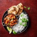 Chicken tikka masala spicy curry meat food Butter chicken, rice and naan bread on red vine dark background. Traditional Indian Royalty Free Stock Photo