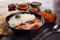 Chicken tikka masala spicy curry meat food in pot with rice and naan bread. indian food on table Royalty Free Stock Photo