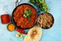 Chicken tikka masala spicy curry meat food in pot with rice and naan bread. indian food on table Royalty Free Stock Photo