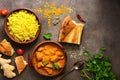 Chicken tikka masala spicy curry meat food , rice and naan bread on a brown rustic background. Indian and UK dish. Top view, copy Royalty Free Stock Photo