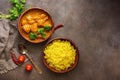 Chicken tikka masala spicy curry meat food , rice and naan bread on a brown rustic background. Indian and UK dish. Top view, copy Royalty Free Stock Photo