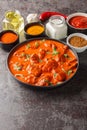 Chicken tikka masala traditional dish of indian cuisine in a black bowl with ingredients over dark concrete background. Vertical Royalty Free Stock Photo