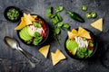 Chicken tortilla chili soup with nachos, avocado, lime, jalapeno. Mexican traditional dish.