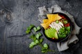 Chicken tortilla chili soup with nachos, avocado, lime, jalapeno. Mexican traditional dish.