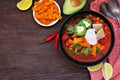 Chicken tortilla soup, top view table scene on a dark wood background Royalty Free Stock Photo