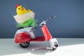 Chicken toys in a basket on a scooter