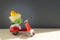 Chicken toys in a basket on a scooter