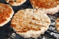 Chicken or turkey burgers for hamburger on grill Royalty Free Stock Photo