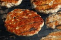 Chicken or turkey burgers for hamburger on grill Royalty Free Stock Photo