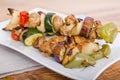 Chicken and vegetable kabobs on white plate Royalty Free Stock Photo