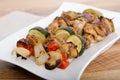 Chicken and vegetable kabobs on white plate Royalty Free Stock Photo