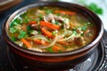 Chicken vegetable soup with parsley in a brown bowl