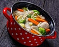 Chicken vegetable soup with pasta in red pot Royalty Free Stock Photo