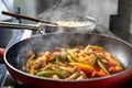 Vegetables and chicken prepared in frying pan