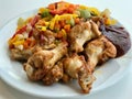 Chicken Wings with Barbecue Sauce and Vegetables Ready to Serve with Plate at Restaurant. Royalty Free Stock Photo