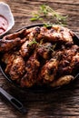 Chicken wings barbeque in a cast iron baking dish with BBQ sauce and rosemary Royalty Free Stock Photo