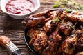 Chicken wings barbeque in a cast iron baking dish with BBQ sauce and rosemary Royalty Free Stock Photo