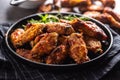 Chicken wings barbeque in a cast iron baking dish with BBQ sauce and rosemary Royalty Free Stock Photo