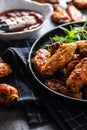 Chicken wings barbeque in a cast iron baking dish with BBQ sauce and rosemary Royalty Free Stock Photo