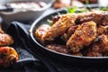 Chicken wings barbeque in a cast iron baking dish with BBQ sauce and rosemary Royalty Free Stock Photo