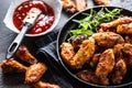 Chicken wings barbeque in a cast iron baking dish with BBQ sauce and rosemary Royalty Free Stock Photo