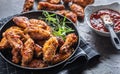 Chicken wings barbeque in a cast iron baking dish with BBQ sauce and rosemary Royalty Free Stock Photo