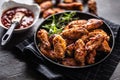 Chicken wings barbeque in a cast iron baking dish with BBQ sauce and rosemary Royalty Free Stock Photo