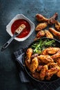 Chicken wings barbeque in a cast iron baking dish with BBQ sauce and rosemary. Royalty Free Stock Photo