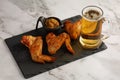 Chicken wings and beer. Hearty and tasty food. Plate of delicious barbecue chicken wings