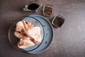 Chicken wings drizzled with soy sauce in a transparent plate for baking in teriyaki sauce. A dish of Asian cuisine Royalty Free Stock Photo