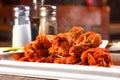 Chicken wings are elegantly presented on a plate, accompanied