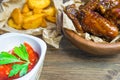 Chicken wings in a fragrant and pungent sauce with sesame seeds. A glass of fresh cold beer and fried potatoes with rustic tomato Royalty Free Stock Photo