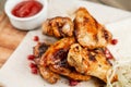 chicken wings grill. Serving on a white plate on a table. Barbecue restaurant menu, a series of photos of different Royalty Free Stock Photo