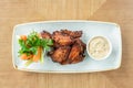 Chicken wings grill. Serving on a white plate on a table. Barbecue restaurant menu, a series of photos of different Royalty Free Stock Photo