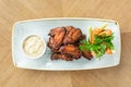 Chicken wings grill. Serving on a white plate on a table. Barbecue restaurant menu, a series of photos of different Royalty Free Stock Photo