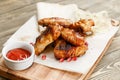 Chicken wings grill. Serving on a wooden Board on a rustic table. Barbecue restaurant menu, a series of photos of Royalty Free Stock Photo