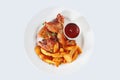 Chicken wings in hot sauce with French fries. An isolated object. Top view Royalty Free Stock Photo
