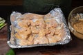 Chicken wings marinated in soy sauce with garlic on foil ready for baking