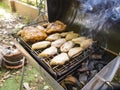 Chicken Wings and Pork Shoulder Grilling on a smoking fire Royalty Free Stock Photo